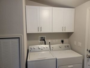 Two Sets of White Color Cupboards in a Laundry Room