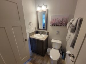 A Small Bathroom With Floral Canvas